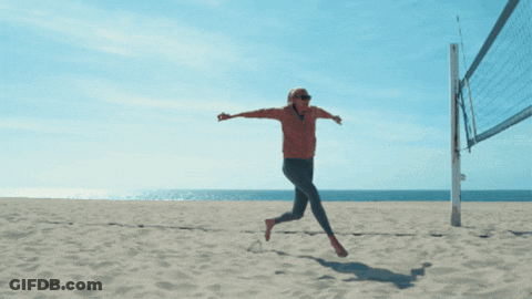 A Man Playing Volleyball On A Beach With A Banner That Says ' Volley ' On It GIF