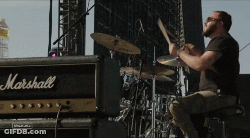 A Man Plays Drums In Front Of A Marshall Amp GIF