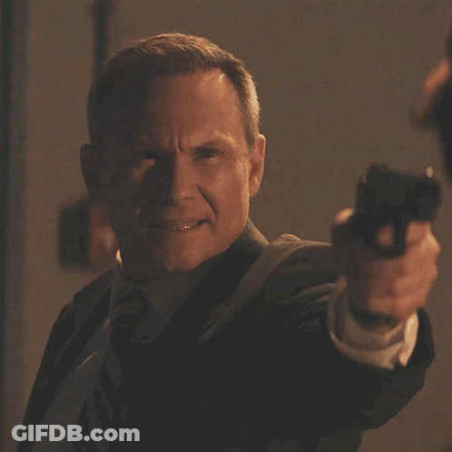 A Man Pointing A Gun With The Words " What Are You Talking About " Behind Him GIF