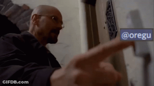 A Man Pointing To A Sign That Says @Oregu GIF