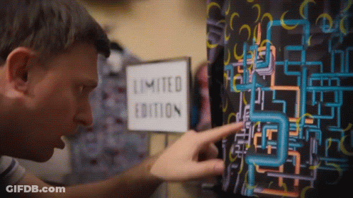 A Man Points At A Limited Edition Sign On A Wall GIF