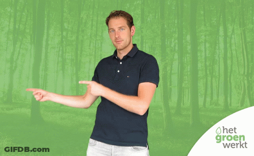 A Man Points To Something In Front Of A Green Background With Het Groen Werkt GIF