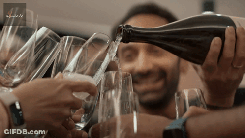 A Man Pouring A Bottle Of Wine Into A Glass GIF