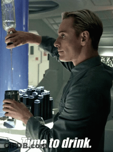 A Man Pouring A Drink Into A Glass With The Words Time To Drink Above Him GIF