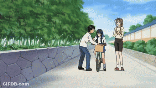 A Man Pushes A Girl On A Bicycle While A Woman Looks On GIF