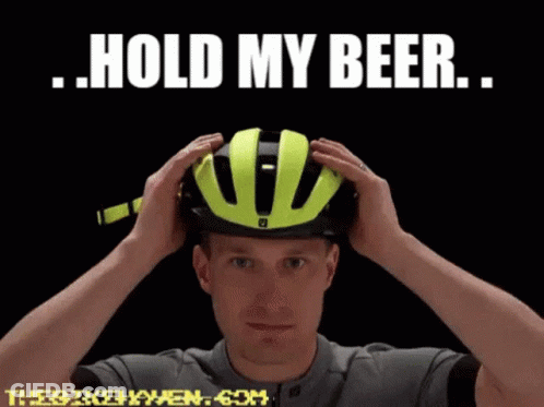 A Man Putting On A Helmet With The Words Hold My Beer GIF