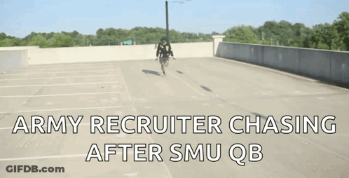 A Man Riding A Bike In A Parking Lot With The Words " Army Recruiter Chasing After Smu Qb " On The Bottom GIF