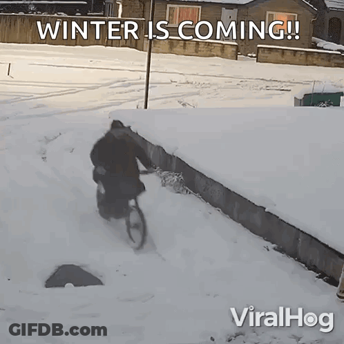 A Man Riding A Bike In The Snow With The Words Winter Is Coming On The Bottom GIF