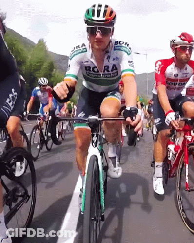 A Man Riding A Bike With Bora Written On His Jersey GIF