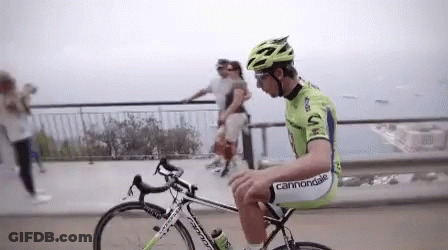 A Man Riding A Bike With The Word Cannondale On His Pants GIF
