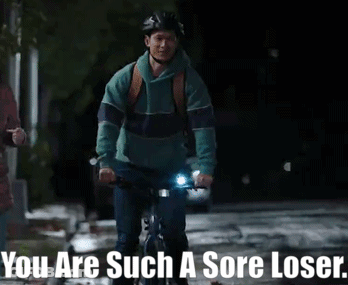 A Man Riding A Bike With The Words " You Are Such A Sore Loser " Above Him GIF