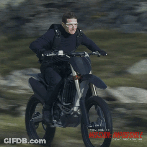 A Man Riding A Dirt Bike With The Word Mission Impossible On The Bottom GIF