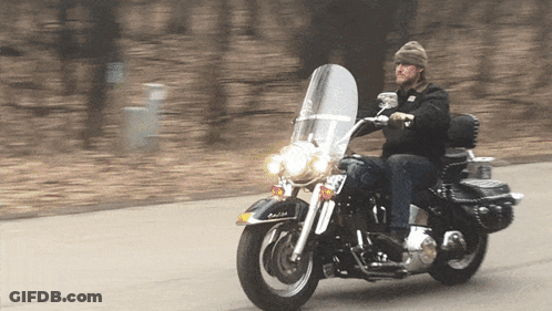 A Man Riding A Harley Davidson Motorcycle With A License Plate That Says Rb GIF