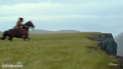 A Man Riding A Horse In A Field With A Disney Logo In The Corner GIF
