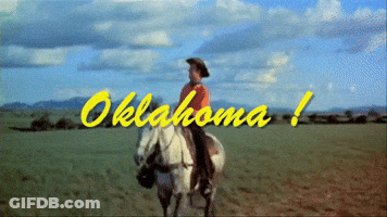 A Man Riding A Horse In A Field With Oklahoma Written In Yellow Letters GIF
