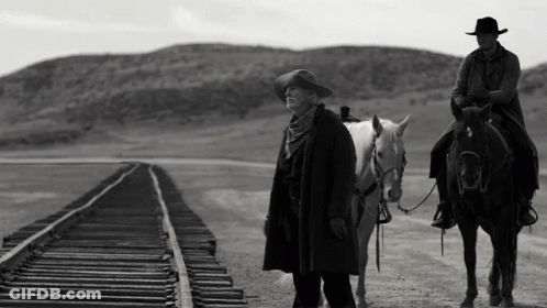 A Man Riding A Horse Next To A Woman On A Train Track GIF