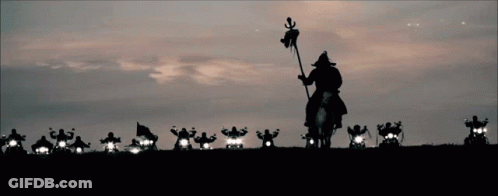 A Man Riding A Horse With A Flag In His Hand Is Leading A Group Of Motorcycle Riders GIF