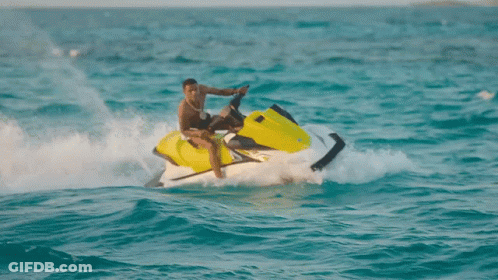A Man Riding A Jet Ski In The Ocean GIF