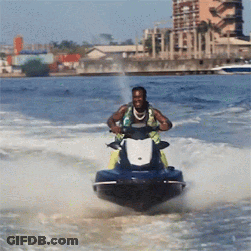 A Man Riding A Jet Ski In The Ocean GIF