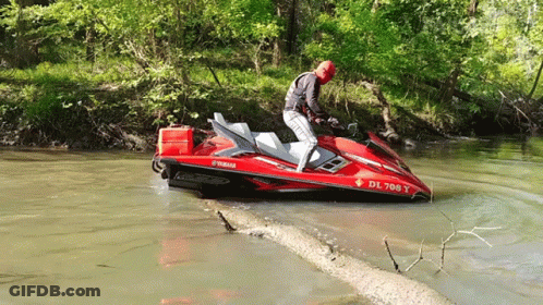 A Man Riding A Red Yamaha Jet Ski In The Water GIF