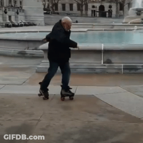 A Man Rollerblading In Front Of A Fountain In A Park GIF