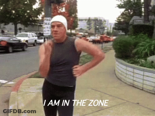 A Man Running Down A Sidewalk With The Words " I Am In The Zone " Written Below Him GIF