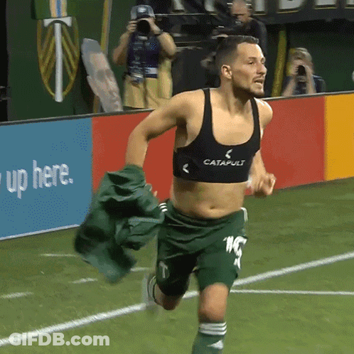 A Man Running On A Soccer Field Wearing A Black Catapult Bra GIF