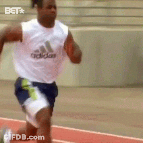A Man Running On A Track Wearing A White Adidas Tank Top GIF