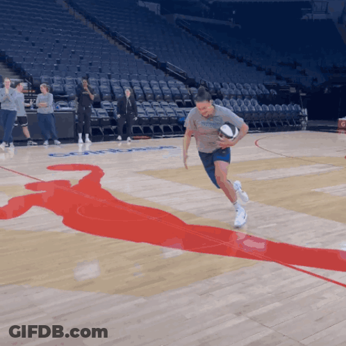 A Man Running With A Basketball On A Basketball Court With A Silhouette Of A Basketball Player On The Floor GIF