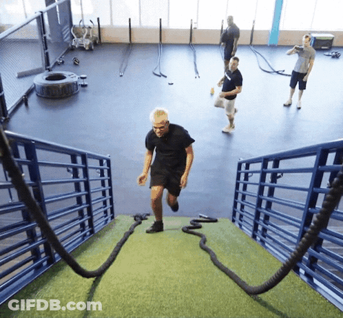 A Man Runs Up A Set Of Stairs With Ropes GIF