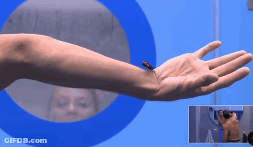A Man 'S Arm Is Shown In Front Of A Blue Circle GIF