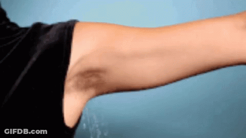A Man 'S Arm With A Black Spot On It GIF
