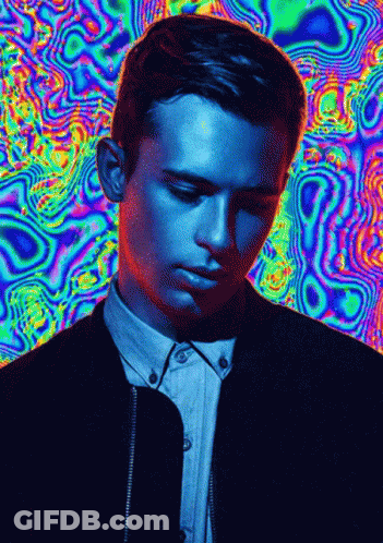 A Man 'S Face Is Against A Colorful Background GIF