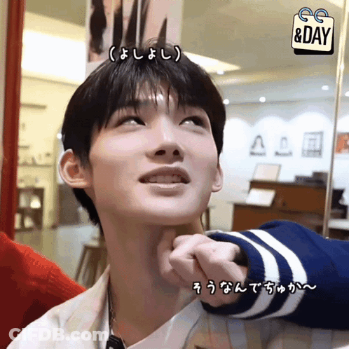 A Man 'S Face Is Being Touched By Someone With A Sign That Says Day GIF
