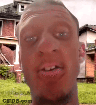 A Man 'S Face Is Shown With A House In The Background GIF
