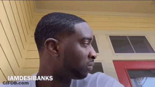 A Man 'S Face Is Shown With The Words Iamdesibanks Above It GIF