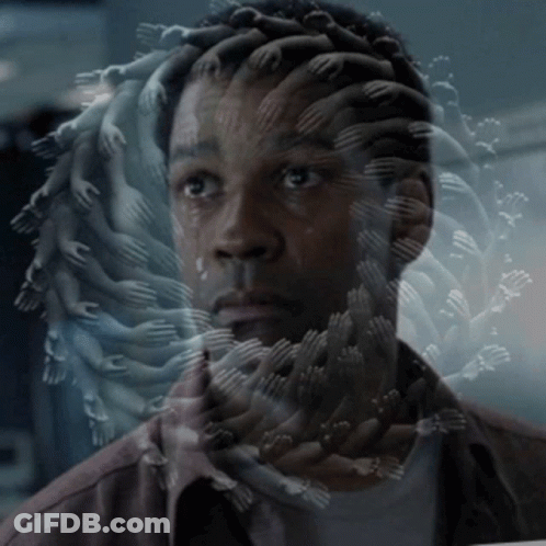 A Man 'S Face Is Surrounded By Many Hands Reaching Out Towards Him GIF