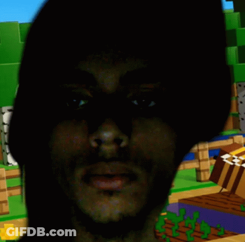 A Man 'S Face Is Visible In The Dark In Front Of A Minecraft Scene GIF