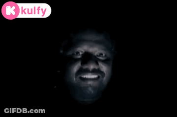 A Man 'S Face Is Visible In The Dark With A Kolfy Logo In The Corner GIF