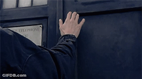 A Man 'S Hand Is Reaching Out To A Police Telephone Box GIF