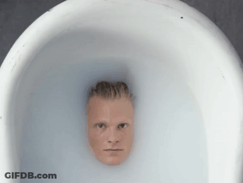 A Man 'S Head Is Sticking Out Of A White Bowl Of Water GIF