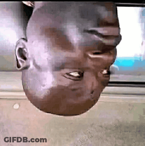 A Man 'S Head Is Upside Down In Front Of A Screen . GIF