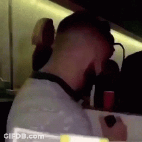 A Man 'S Head Is Visible In A Blurry Photo While Holding A Cell Phone . GIF