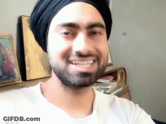 A Man's Staged Smile GIF