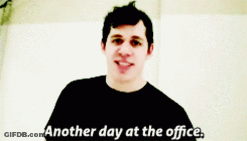 A Man Says " Another Day At The Office " In A Black Shirt GIF