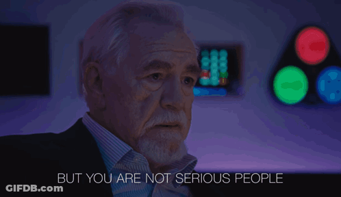A Man Says But You Are Not Serious People In A Dark Room GIF