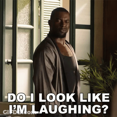 A Man Says Do I Look Like I 'M Laughing While Standing In Front Of A Window GIF