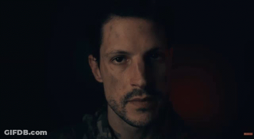 A Man Says " Glad You Made It Here Safely " In A Dark Room GIF