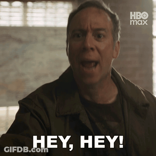 A Man Says " Hey Hey " In Front Of A Hbo Max Logo GIF