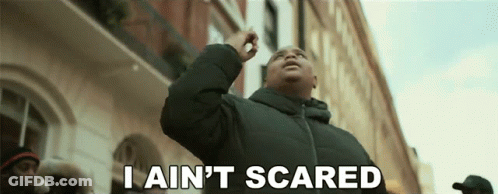 A Man Says I Ain 'T Scared In Front Of A Building GIF